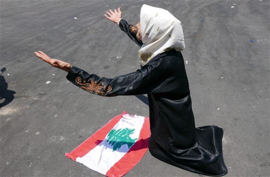 Een Libanese vrouw voor de vlag van haar land (foto: Elisa Gestri)